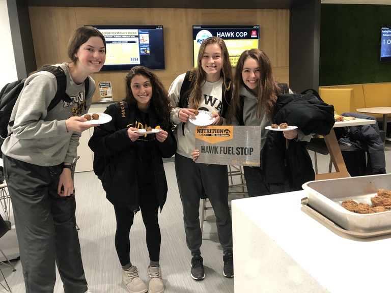 Student-athletes sample new foods at a Hawk Fuel Stop in Gerdin Athletic Learning Center.